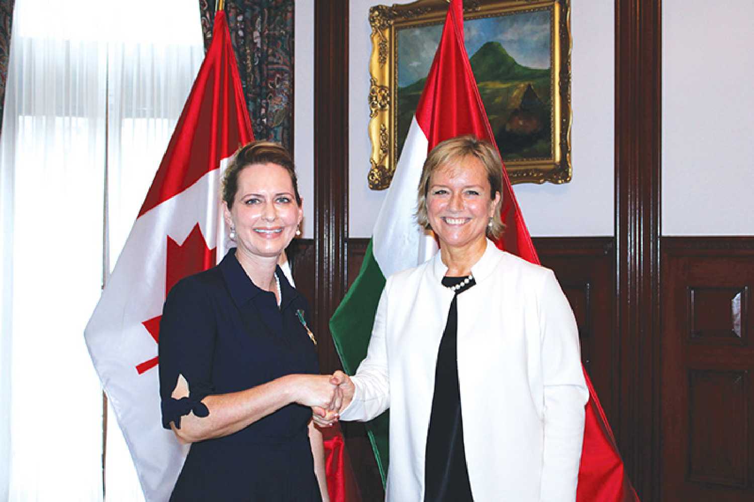 Candace Barta-Bonk accepting the Knights Cross of the Order of Merit of Hungary from ambassador Mria Vass-Salazar